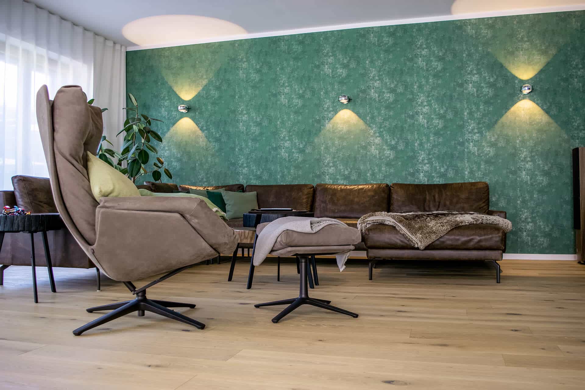 Massivholz Dielenboden im Wohnzimmer mit grauem Sessel und Sofa