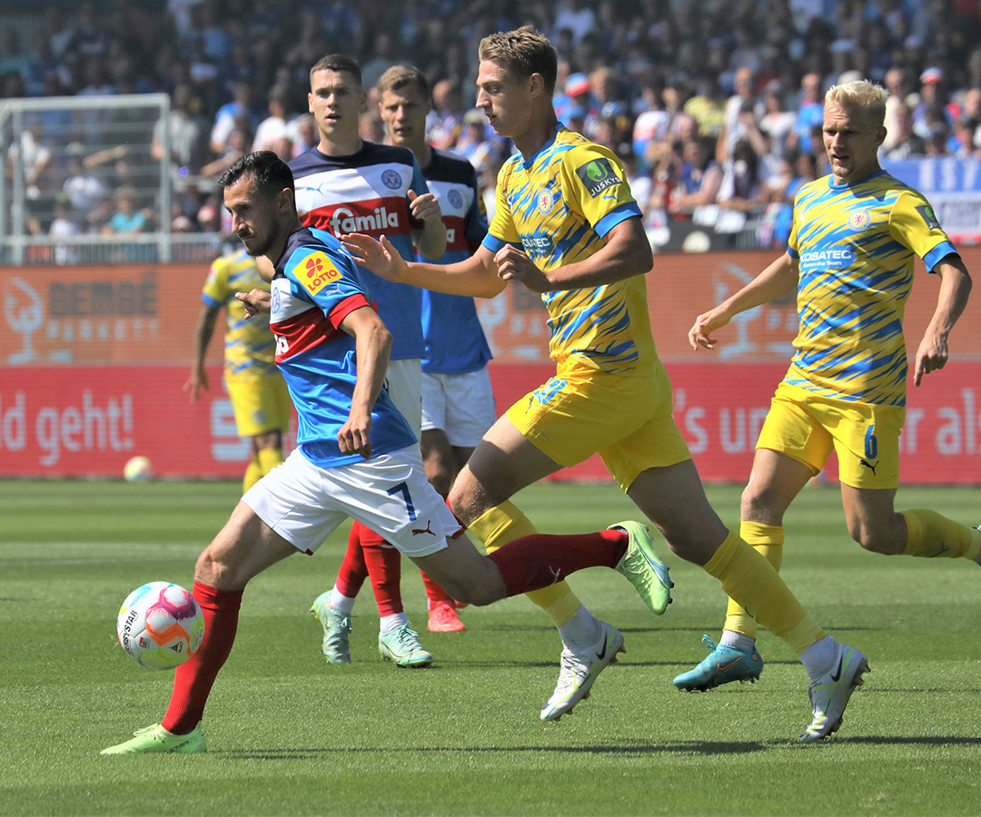 Steven Skrzybski umringt von Braunschweig Spielern mit Bembé Parkett Werbung